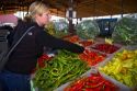 Woman shopping for a variety of peppers at an outdoor farmers' market in Fruitland, Idaho, USA. MR