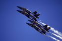The Blue Angels F/A-18 Hornets fly in formation.