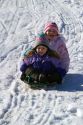 Sledding on a snowy hill near Boise, Idaho, USA.