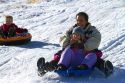Sledding on a snowy hill near Boise, Idaho, USA.