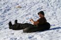 Sledding on a snowy hill near Boise, Idaho, USA.
