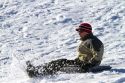 Sledding on a snowy hill near Boise, Idaho, USA.