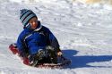 Sledding on a snowy hill near Boise, Idaho, USA.