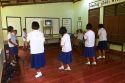 Thai elementary students dance with direction from a television at school on the island of Ko Samui, Thailand.