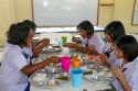 Thai elementary school students eat lunch on the island of Ko Samui, Thailand.