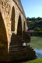 Six-arched Roman bridge spanning the Arga River on the Way of St. James pilgrimage route in Puente La Reina, Navarra, Spain.
