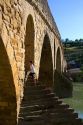 Six-arched Roman bridge spanning the Arga River on the Way of St. James pilgrimage route in Puente La Reina, Navarra, Spain.
