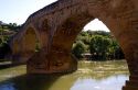 Six-arched Roman bridge spanning the Arga River on the Way of St. James pilgrimage route in Puente La Reina, Navarra, Spain.